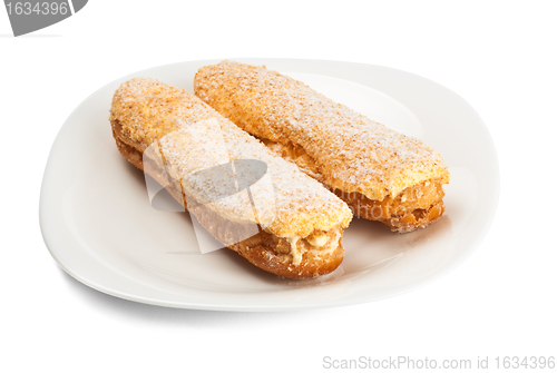 Image of two tasty eclairs on dish