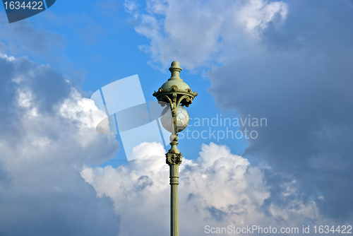 Image of vintage street lamp on cloud sky background