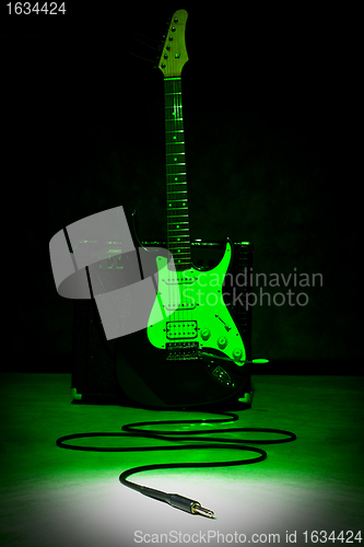 Image of guitar and plug in spot of light