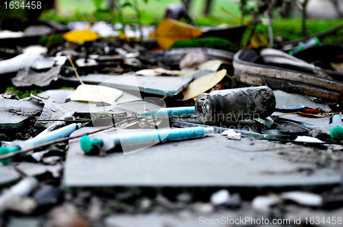 Image of narcotic syringes in the junkyard