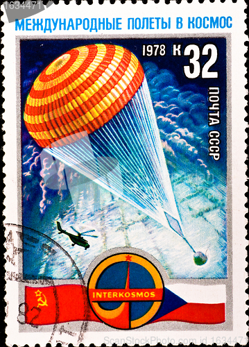 Image of postage stamp shows parachute with spacecraft capsule