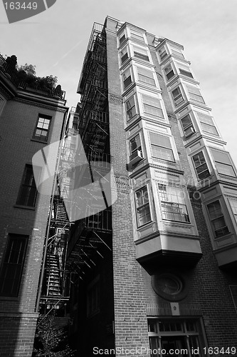 Image of Tall building with fire escape and bay windows