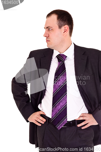 Image of serious businessman looks somewhere