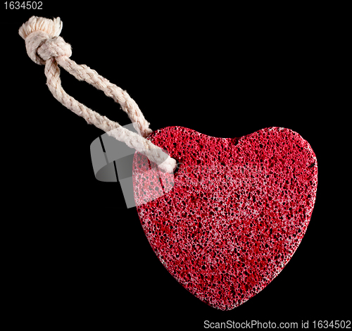 Image of red heart-shaped stone with rope