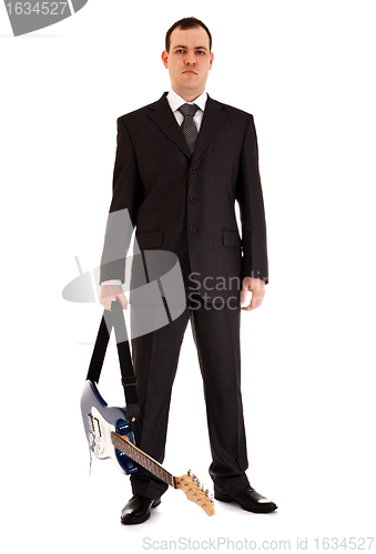 Image of man in black suit stand with electric guitar