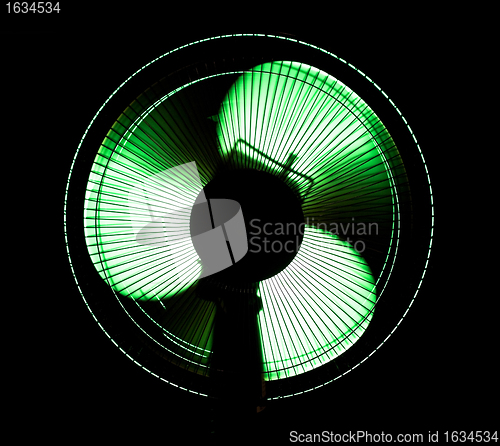 Image of big office fan in green light