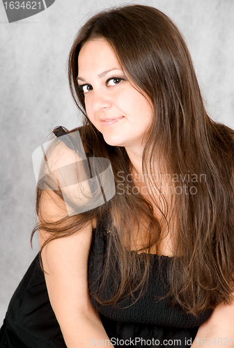 Image of smiling young woman with long brown hair