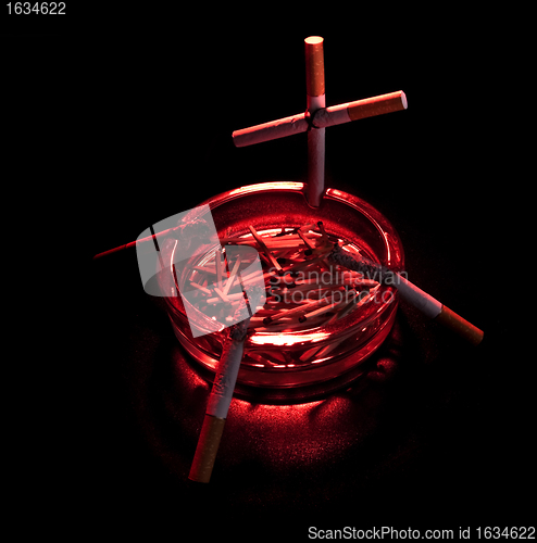 Image of cigarette cross in ashtray