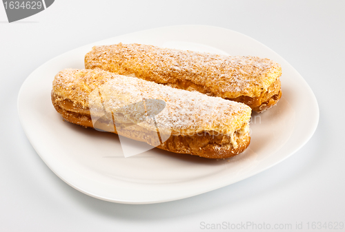 Image of two eclairs on white dish