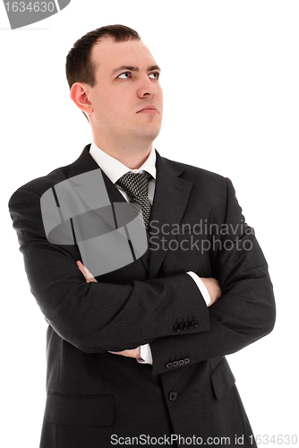 Image of serious businessman looks somewhere