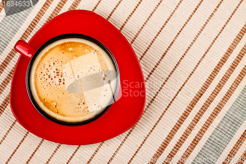 Image of red coffee cup on tablecloth