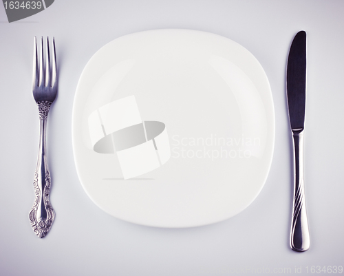 Image of empty white dish knife and fork