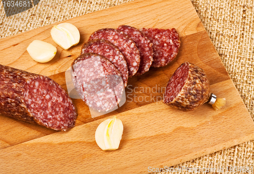 Image of sausage and garlic on cutting board