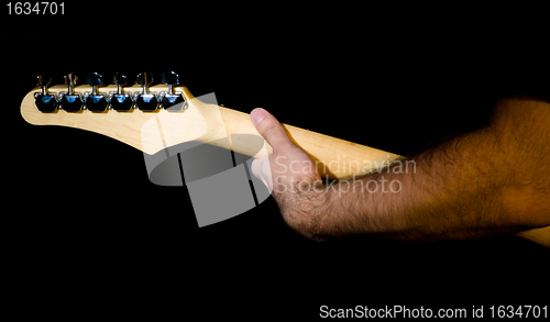 Image of hand on guitar neck