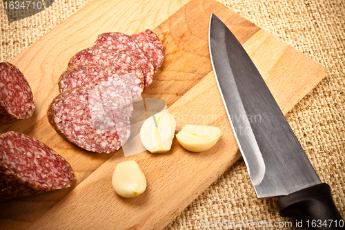 Image of sausage, garlic and knife