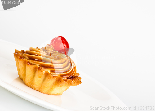 Image of cake with cherry on dish