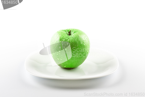 Image of green apple on white dish