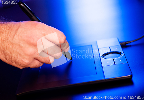 Image of man's hand on drawing tablet