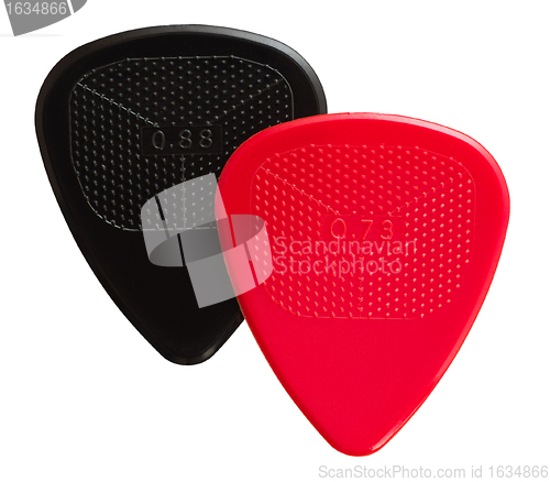 Image of two ribbed guitar plectrums