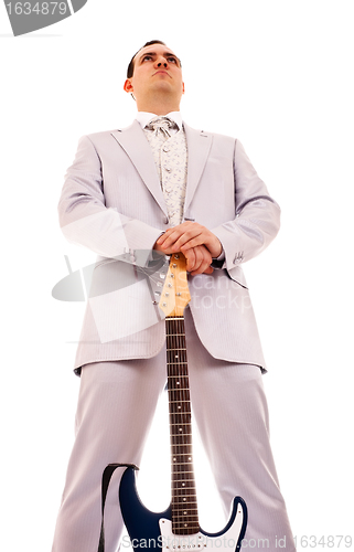 Image of man standing with electro guitar