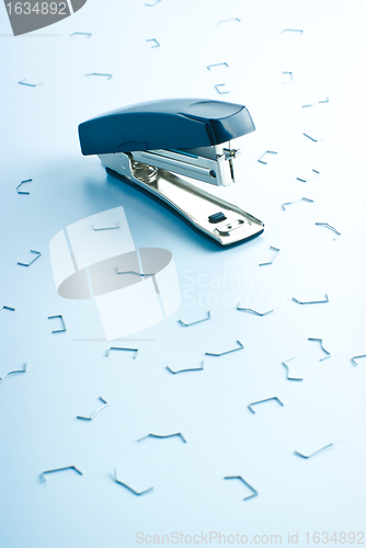 Image of office stapler and many clips
