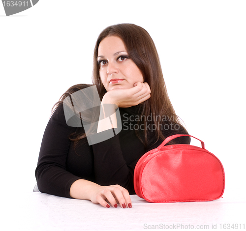 Image of young woman with red cosmetic bag