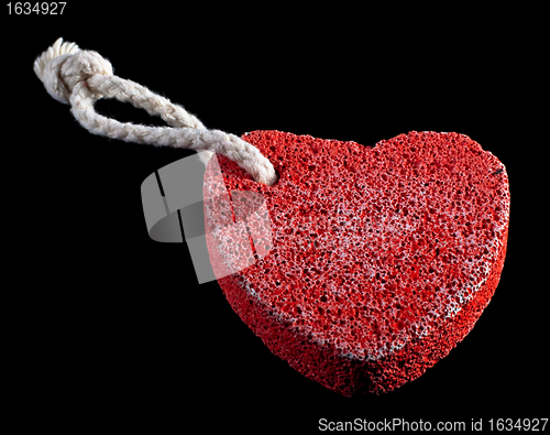 Image of red heart-shaped stone with rope