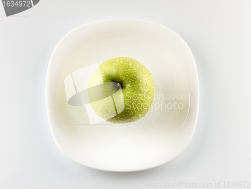 Image of green apple on white dish