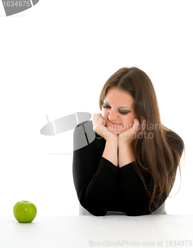 Image of girl with grimace on her face and green apple