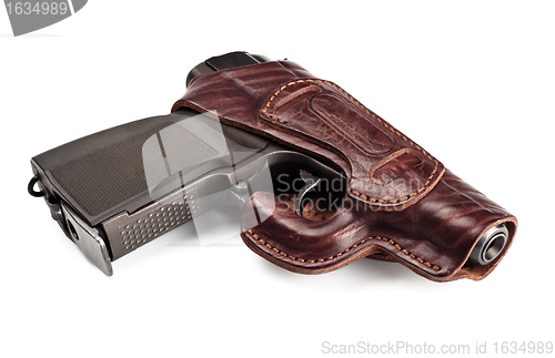 Image of vintage pistol in leather holster