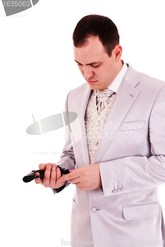 Image of man in white suit reload the gun