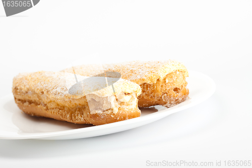 Image of two eclairs on white dish