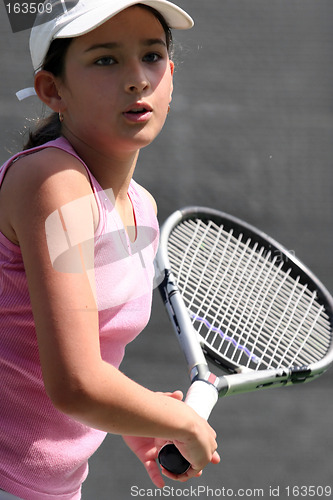 Image of Young girl playing tennis