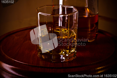 Image of whiskey glass on wooden tray