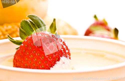Image of strawberry in sour cream