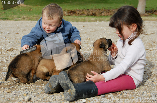 Image of children and puppies