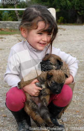 Image of smiling girl and puppies