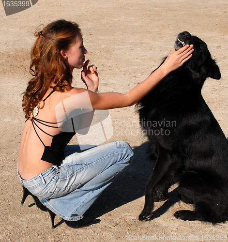 Image of girl and black dog