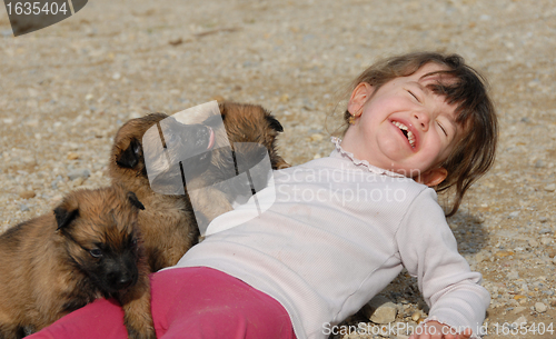 Image of laughing girl and puppies