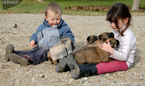 Image of children and puppies