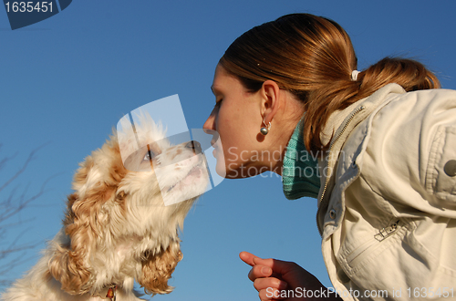 Image of kissing woman and dog