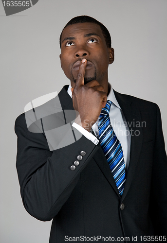 Image of Businessman looking up and thinking