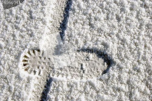 Image of Human foot and bicycle wheel imprint 