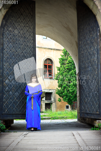 Image of medieval girl on street of old town