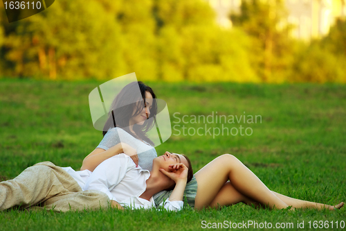 Image of couple laying on park lawn