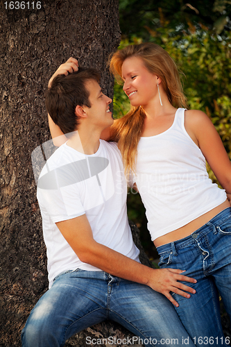 Image of smiling couple next tree