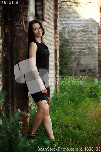 Image of girl standing amongst ruins