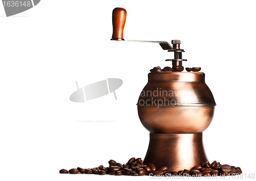 Image of vintage coffee grinder standing on beans