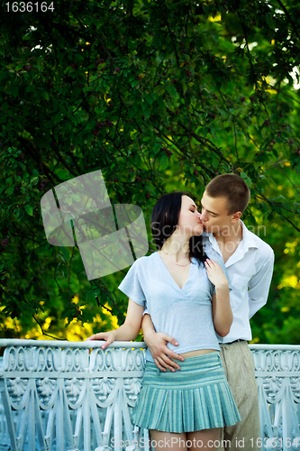 Image of kissing couple in the park