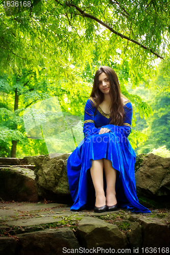 Image of medieval girl sitting on stone stage